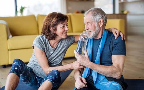 Una pareja bebe agua para mantenerse hidratados